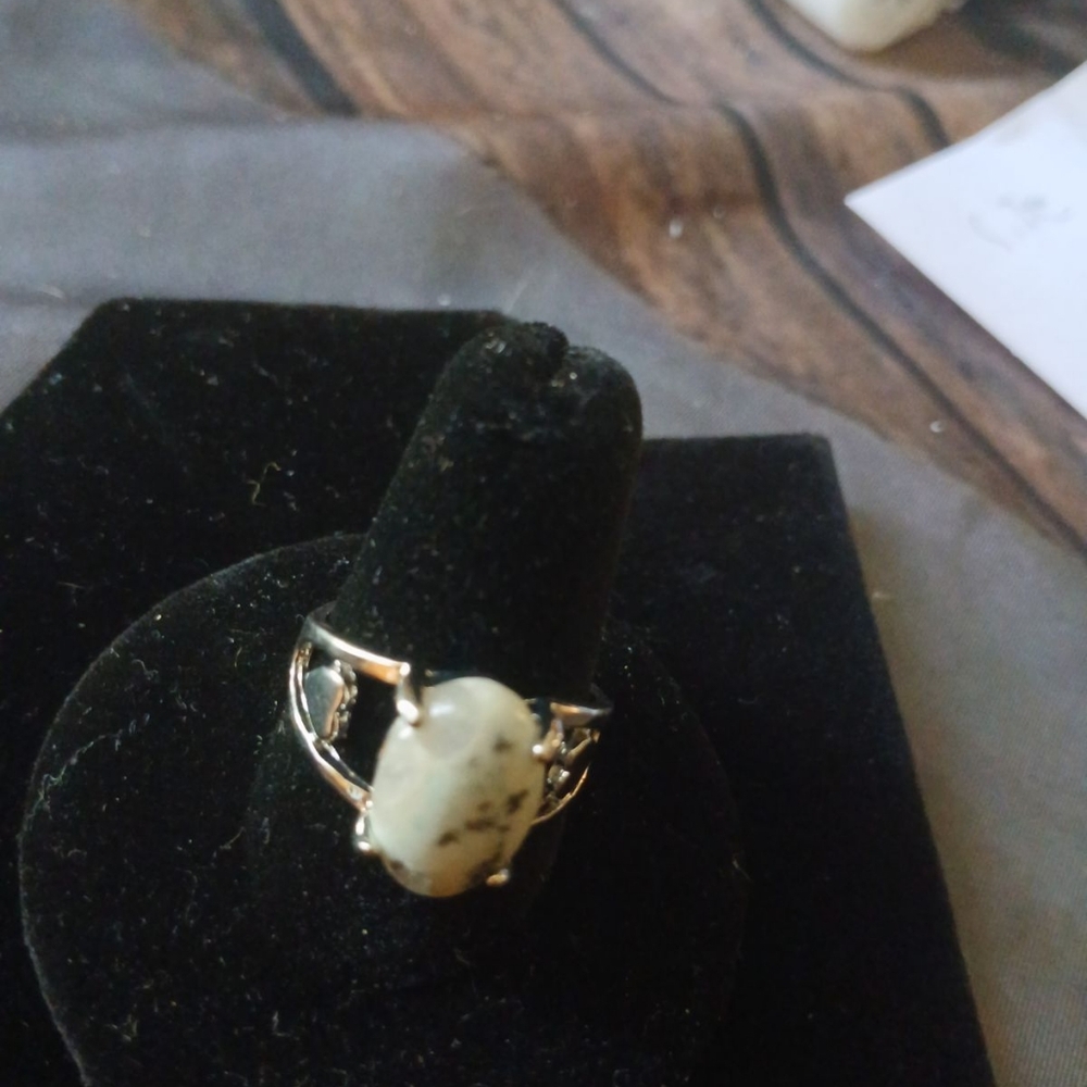 Silver ring with white with black specks